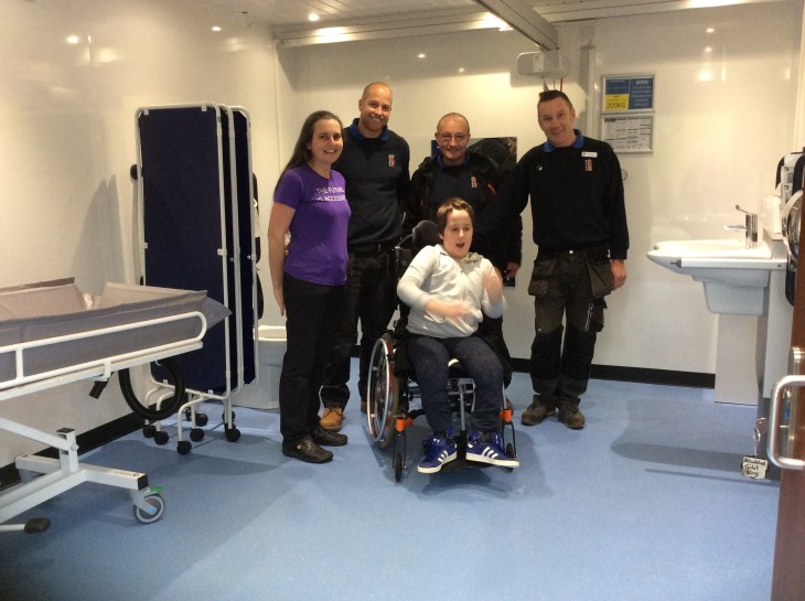 3 men wearing Newquay Zoo uniforms and a woman wearing a purple top which says 