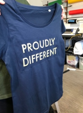 A dark blue T-shirt with the words "Proudly Different" on it.